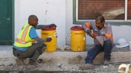 Anthony Harris and foreman Angel Gonzalez take a water break while working with E-Z Bel Construction on pipes along Fredericksburg Road during an excessive heat warning in San Antonio, Texas, U.S. July 19, 2022.  REUTERS/Lisa Krantz

