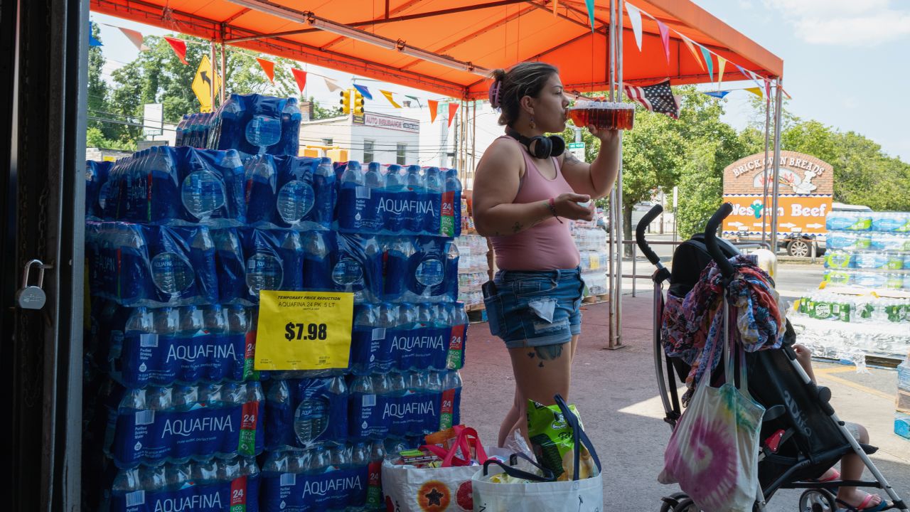 Water is displayed for sale outside of a Staten Island grocery store on a hot Tuesday afternoon in New York City.