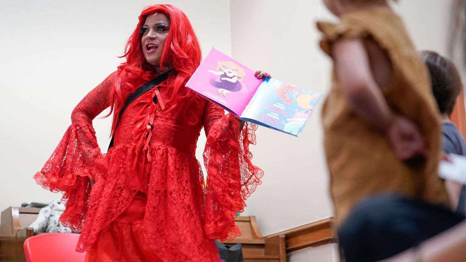 The drag queen Flame reads stories to children during Drag Queen Story Hour at a public library in New York on June 17, 2022.