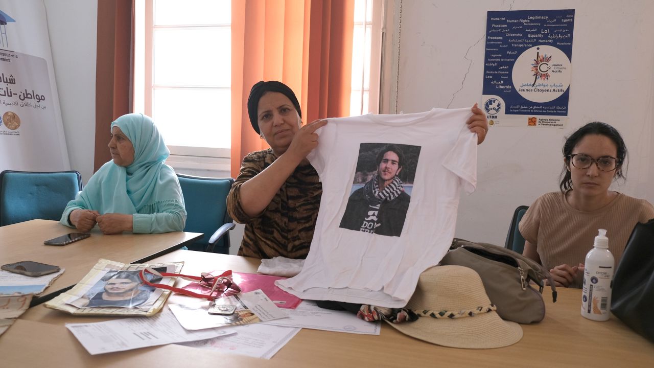 Samia Jabloun holds up a t-shirt with a photo of her son Fadi who went missing in the Mediterranean on February 17, 2021, while he was on an undocumented migrant boat heading to Italy.