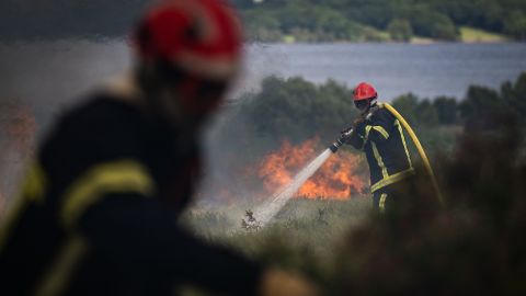 Firefighters spray water on a wildfire in the Monts d'Arree, in Brittany, north-western France.