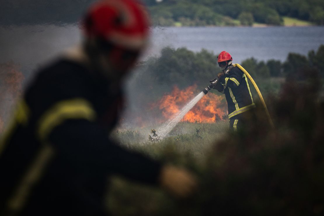 Firefighters spray water on a wildfire in the Monts d'Arree, in Brittany, north-western France.