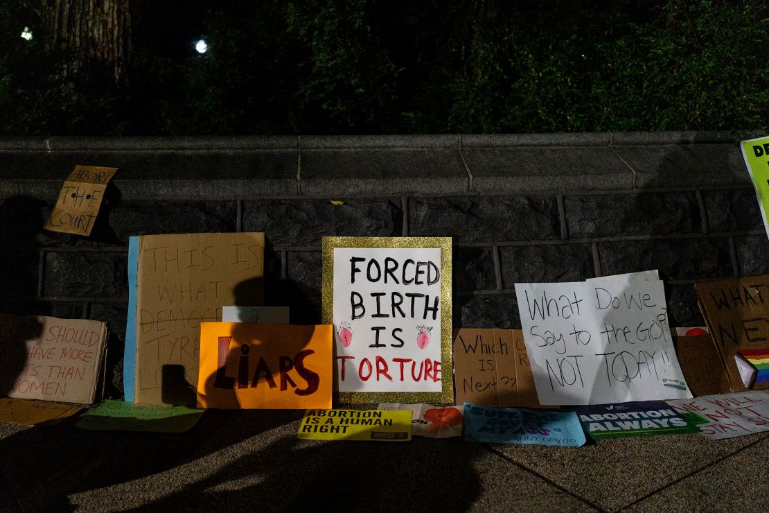 Signs supporting abortion access are displayed near the Supreme Court in Washington on June 24, 2022. 