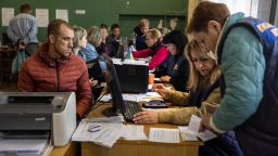 Internally displaced Ukrainians, (L), who look exhausted from their evacuation from frontline areas, register at a government reception center on May 04, 2022 in Kryvyi Rih, Ukraine. The Ukrainian city and district of Kryvyi Rih, known as an industrial center and the hometown of President Volodymyr Zelensky, lies less than 70km north of Russian-occupied areas in nearby Kherson Oblast, where invading Russian forces have sought to create a land bridge between the Crimean peninsula and  the eastern Donbas region.