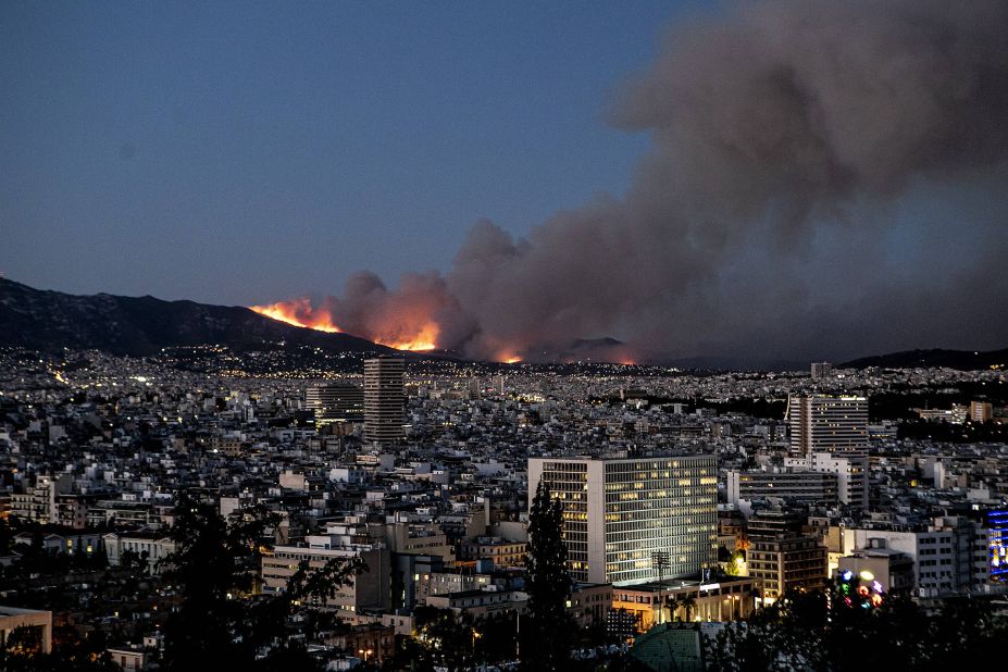 A wildfire burns atop a mountain in the northern suburbs of Athens on July 19.