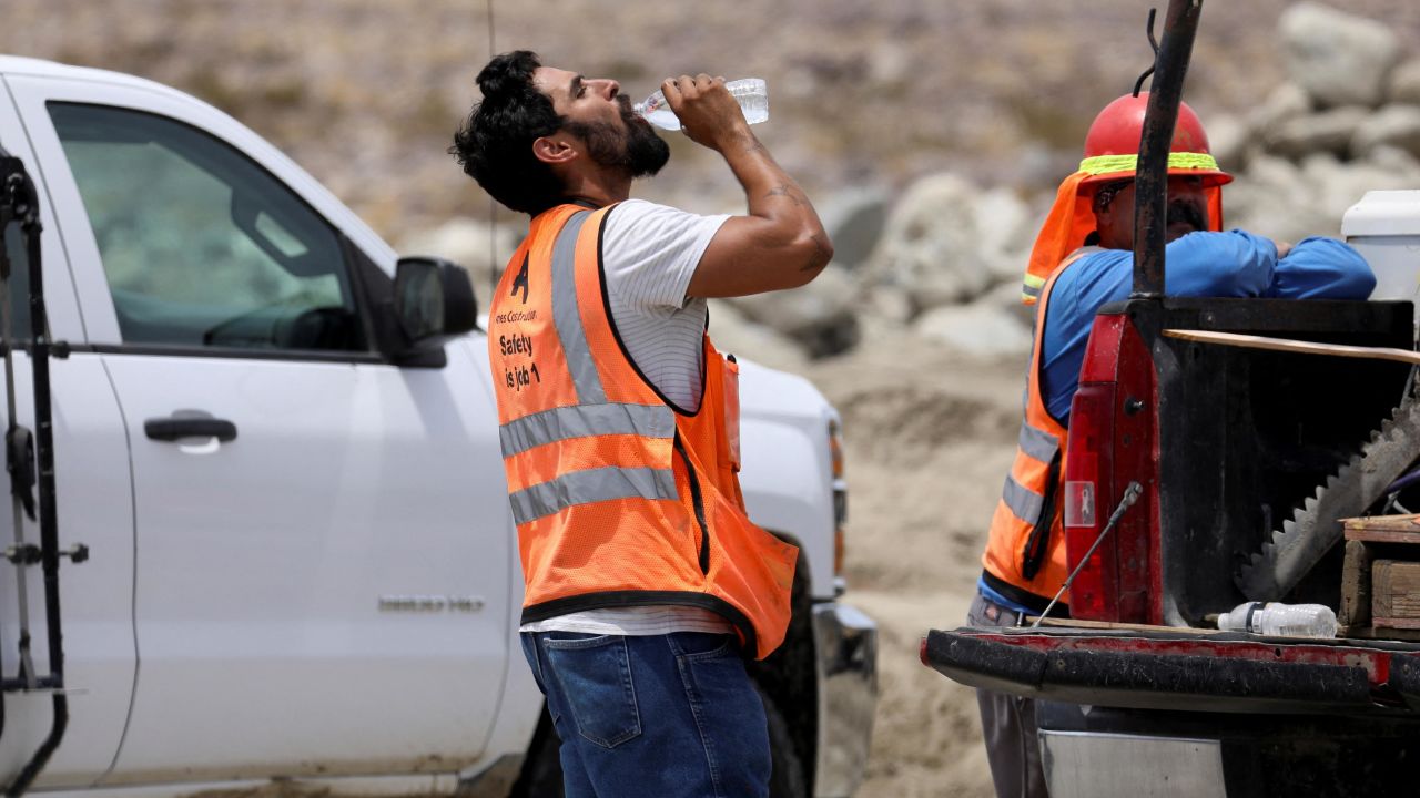 A construction worker drinks water in temperatures that have reached well above triple digits in Palm Springs, California, on Wednesday.