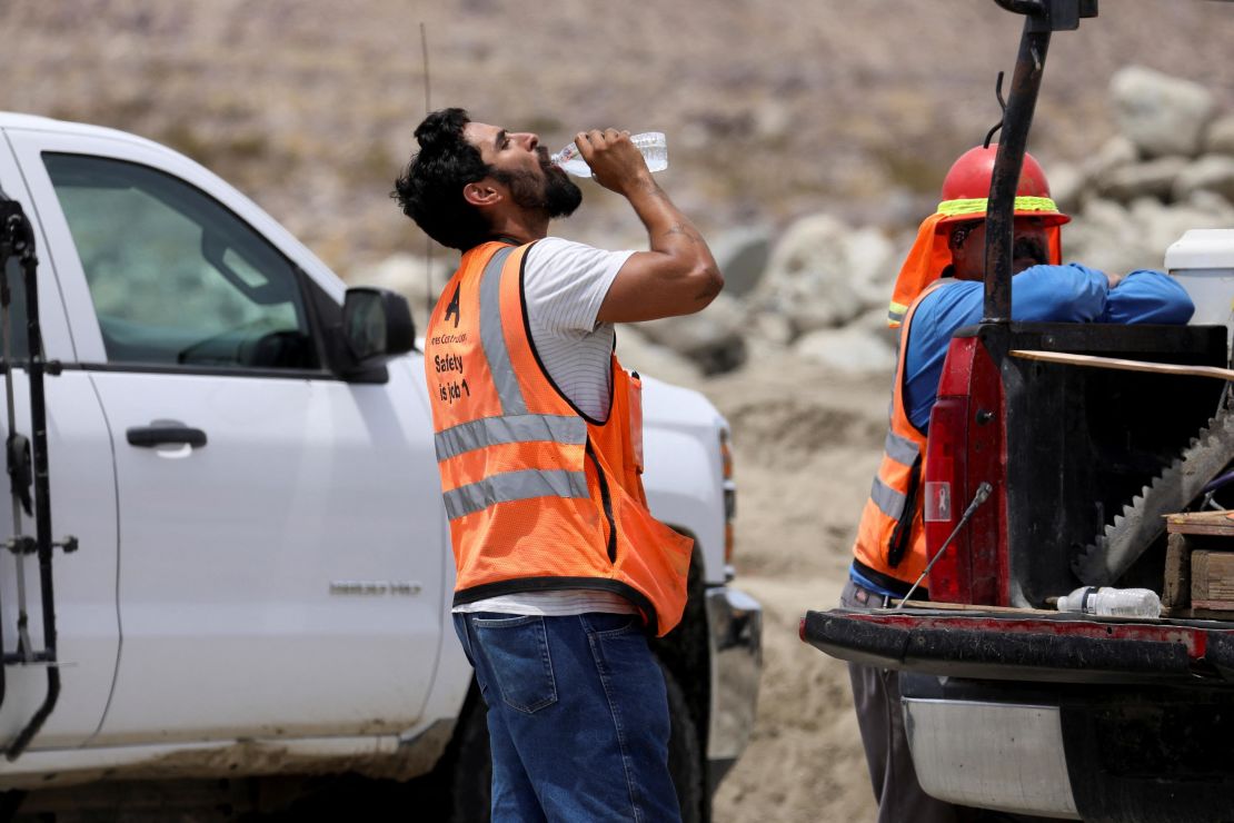 A construction worker drinks water in temperatures that have reached well above triple digits in Palm Springs, California, on Wednesday. 