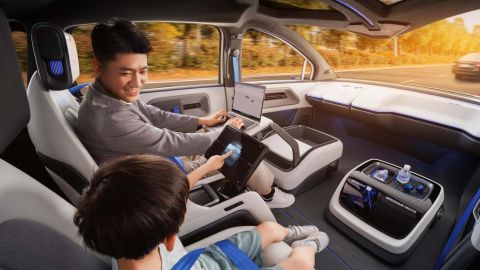A promotional photo from Baidu showing passengers looking at screens in the back of its new robotaxi vehicle.