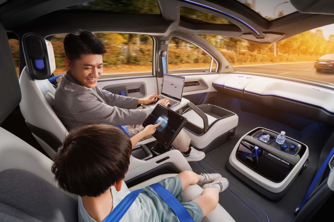 A promotional shot from Baidu showing passengers looking at screens in the backseat of its new robotaxi vehicle.