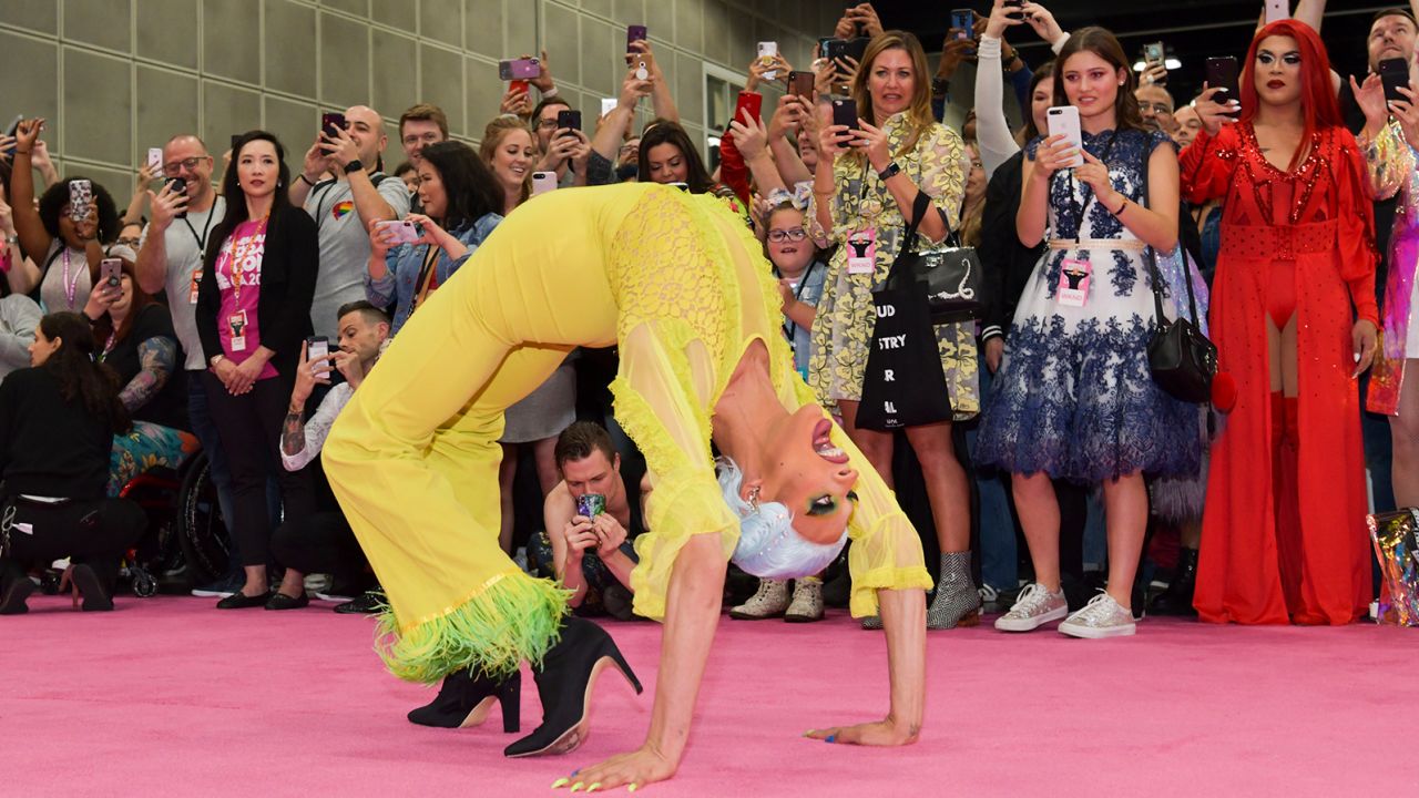 Drag queen Yvie Oddly, who has hypermobile Ehlers-Danlos syndrome, crab walks down the pink carpet at RuPaul's DragCon LA in 2019.