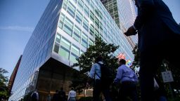 Workers cross the street at Goldman Sachs headquarters in New York, US, on Wednesday, June 15, 2022. The Securities and Exchange Commission is looking into whether some investments for the funds are in breach of ESG metrics promised in marketing materials, one of the people said. 