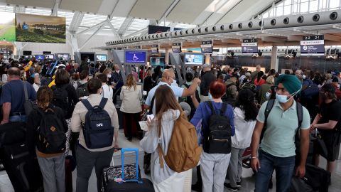 MISSISSAUGA, ON - JUNE 30: Travelers wearing face masks wait to check-in at Toronto Pearson International Airport on June 30, 2022 in Mississauga, Ontario. 