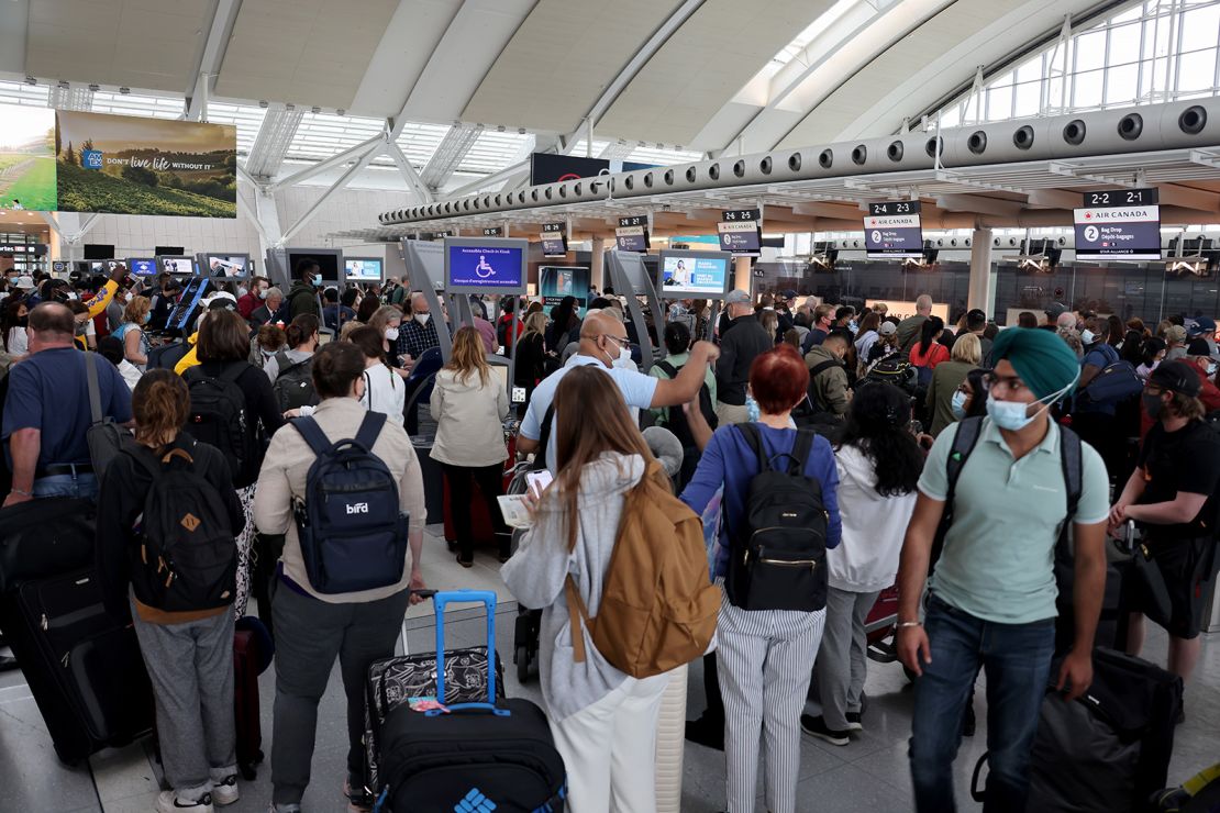 Travelers line up at Toronto Pearson International Airport on June 30, 2022. More than half of the airport's recent flights have been delayed.