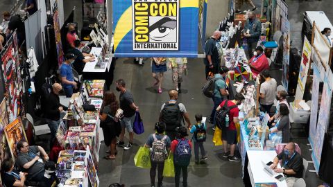 Comic-Con attendees walk down an aisle of the convention show floor during Preview Night at the 2022 Comic-Con International at the San Diego Convention Center on Wednesday, July 20, 2022.