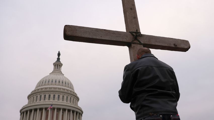 WASHINGTON, DC - JANUARY 06: Supporters of U.S. President Donald Trump pray outside the U.S. Capitol January 06, 2021 in Washington, DC. Congress will hold a joint session today to ratify President-elect Joe Biden's 306-232 Electoral College win over President Donald Trump. A group of Republican senators have said they will reject the Electoral College votes of several states unless Congress appoints a commission to audit the election results. (Photo by Win McNamee/Getty Images)