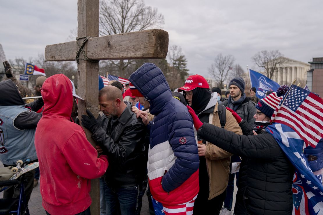 Demonstrators pray outside the US Capitol in Washington on  January 6, 2021.