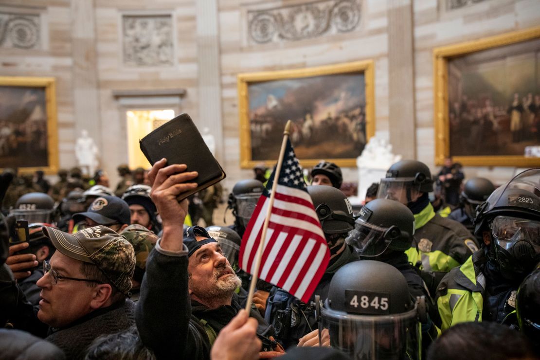 A protester holds up a Bible amid the crowd storming the US Capitol Rotunda in Washington  on January 6, 2021. 