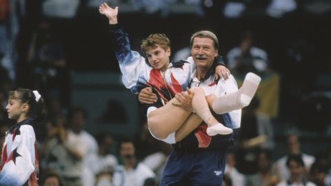 Kerri Strug of the United States is carried by coach Bela Karolyi during the team competition of the Women's Gymnastics event of the 1996 Summer Olympic Games held on July 23, 1996 in the Georgia Dome in Atlanta.