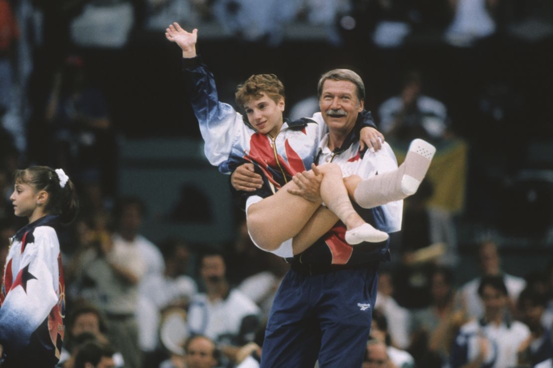 Kerri Strug of the United States is carried by coach Bela Karolyi during the team competition of the Women's Gymnastics event of the 1996 Summer Olympic Games held on July 23, 1996 in the Georgia Dome in Atlanta.