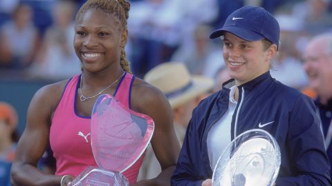 Kim Clijsters, right, and Serena Williams pose with their trophies after the match at the Indian Wells Tennis Gardens in Indian Wells, California.