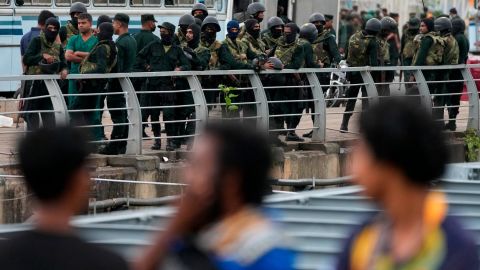 Army soldiers stand guard near a barricade following the eviction of protesters in Colombo, July 22, 2022.