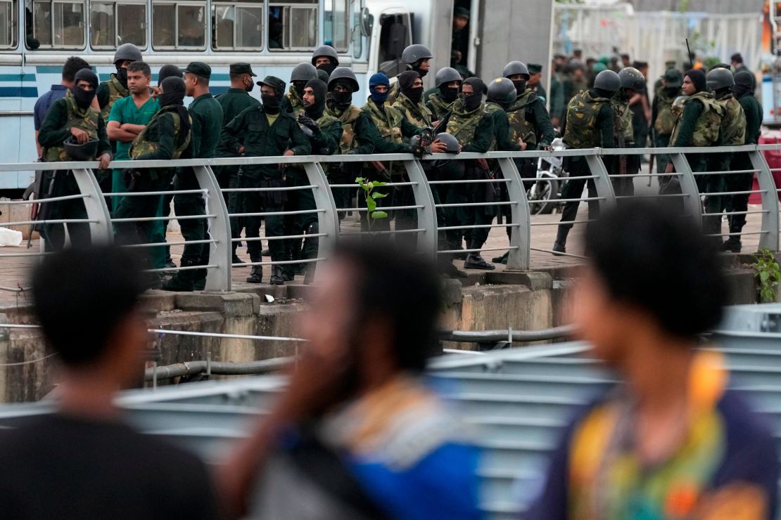 Army soldiers stand guard near a barricade following the eviction of protesters in Colombo, July 22, 2022.