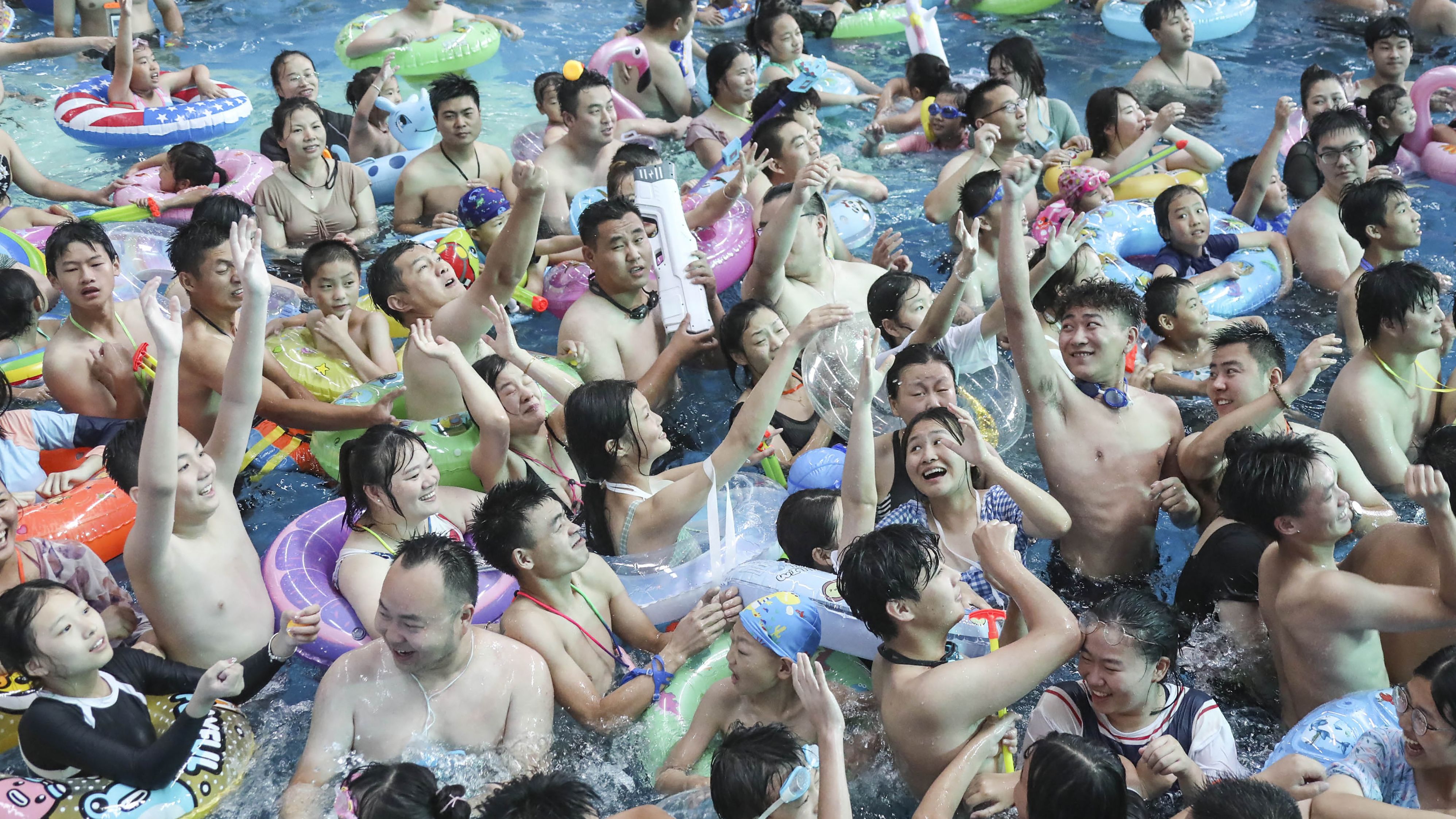 People cool off in a pool at a water park in Huaian, in China's eastern Jiangsu province, July 18.