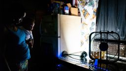 HOUSTON, TEXAS - JULY 21: Yvette Johnson, who goes by Tootie, holds her child near a window fan in her home during a heatwave on July 21, 2022 in Houston, Texas. "Its too much heat inside my home. Sometimes, I go into a panic attack-I don't know, i'm just uncomfortable inside and out. I'm diabetic and the heat hasn't been good for me. We have seven fans in the house, the air conditioning works barely; we have two air conditioning systems that work sometimes, but we're finding a way I guess" Pruitt said. Excessive heat warnings have been issued across Texas with a predicted high of 102 degrees in Houston. (Photo by Brandon Bell/Getty Images)