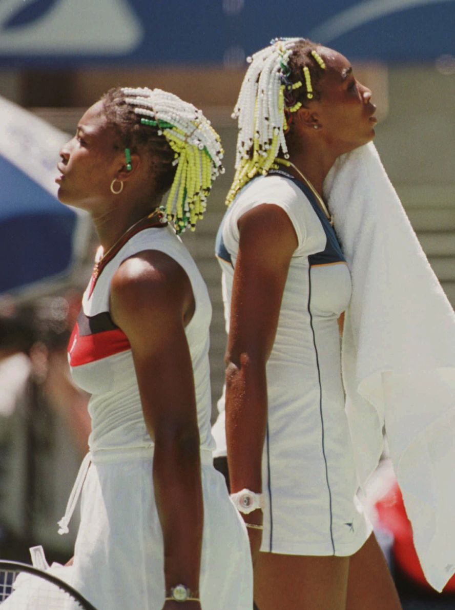 Serena, left, walks past Venus as they played against each other in the second round of the Australian Open in 1998. It was Serena's first grand slam tournament. Venus won the match 7-6, 6-1.