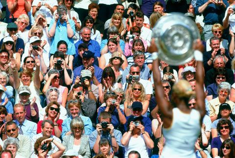 Serena poses with the trophy after winning her first Wimbledon title in 2002. She was No. 1 in the world at the age of 20.