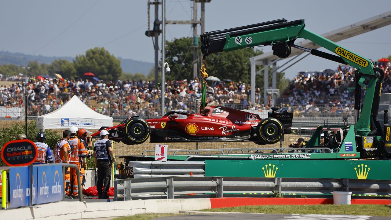 Track marshals remove Leclerc's after he crashed into the track wall.