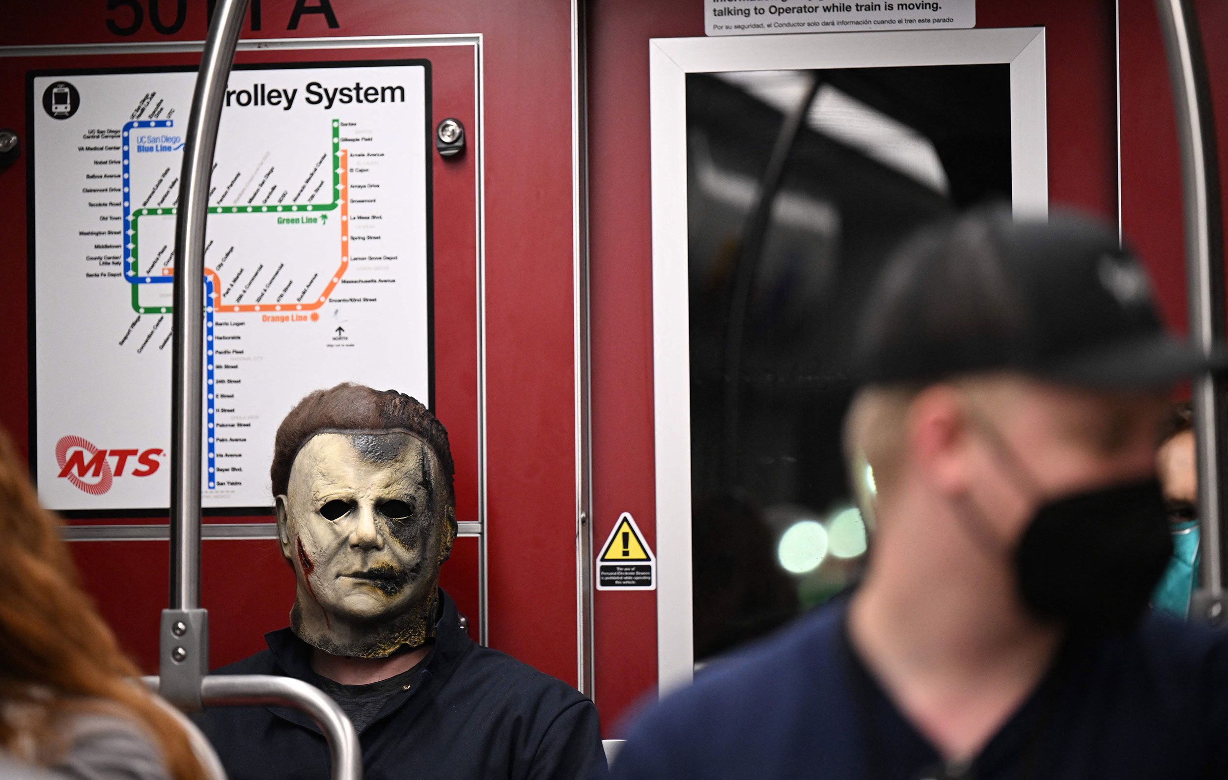 A cosplayer dressed as Michael Myers from the 'Halloween' movies rides the trolley on July 21.