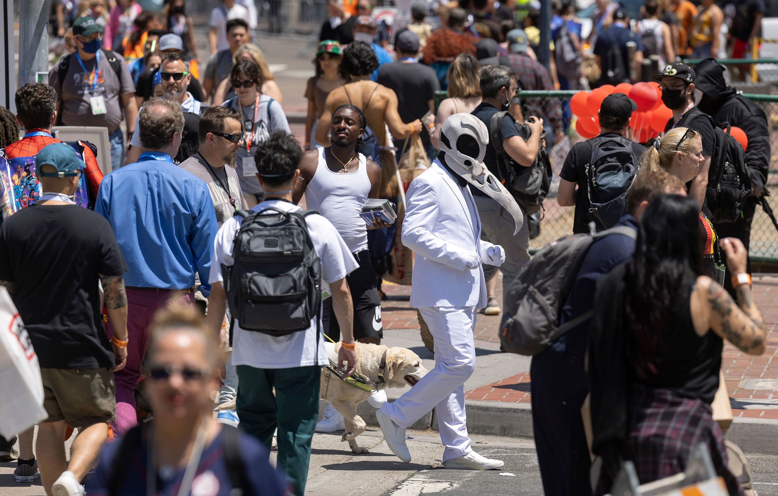 People cross San Diego's Harbor Drive on July 21.