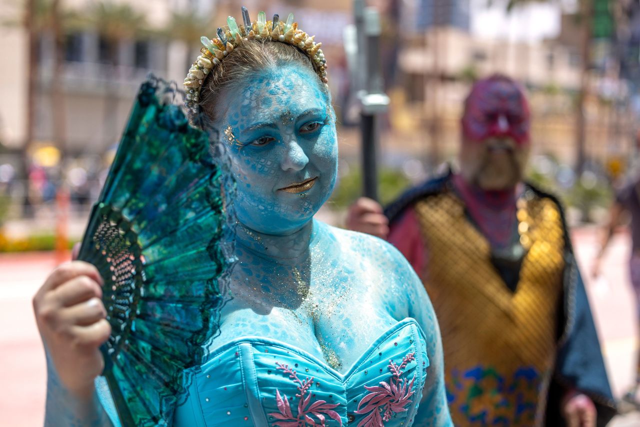 Kristin Ringard, dressed as an undersea god, waves her fan outside the San Diego Convention Center on July 21.