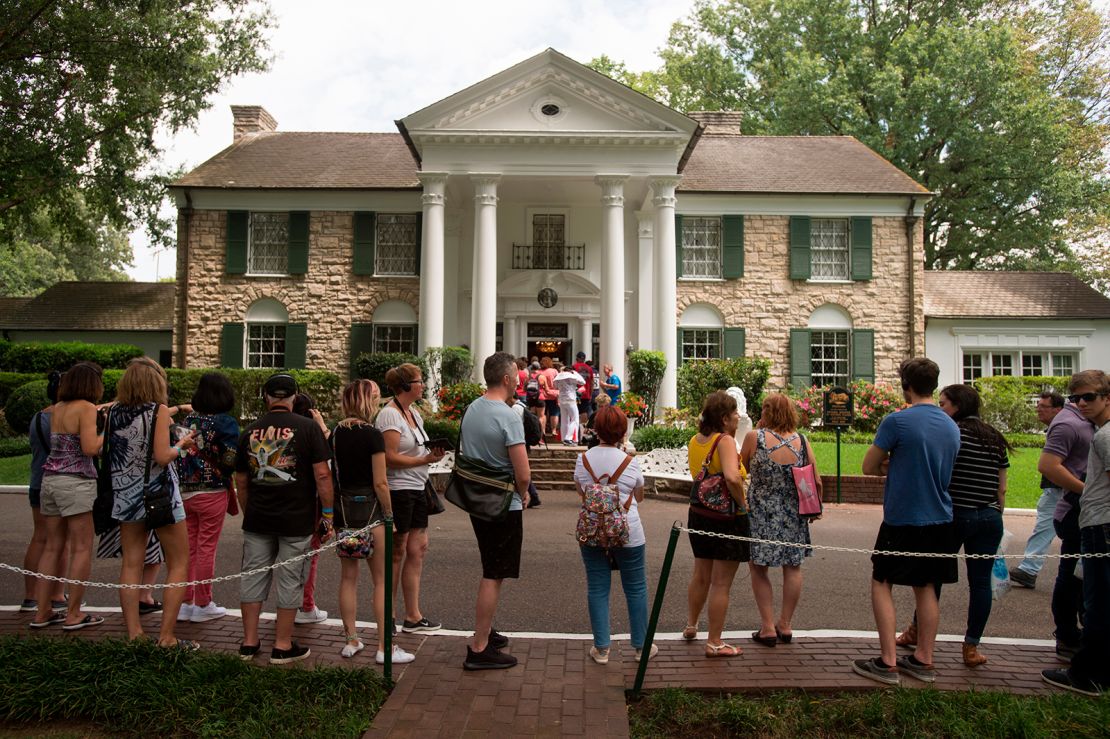 Fans wait in line outside Graceland, Elvis Presley's Memphis home, in Memphis, Tennessee, August 15, 2017.