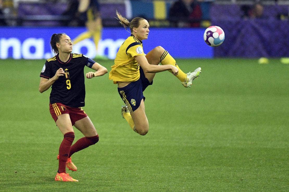Sweden defender Magdalena Eriksson (right) kicks the ball next to Belgium striker Tessa Wullaert (left).