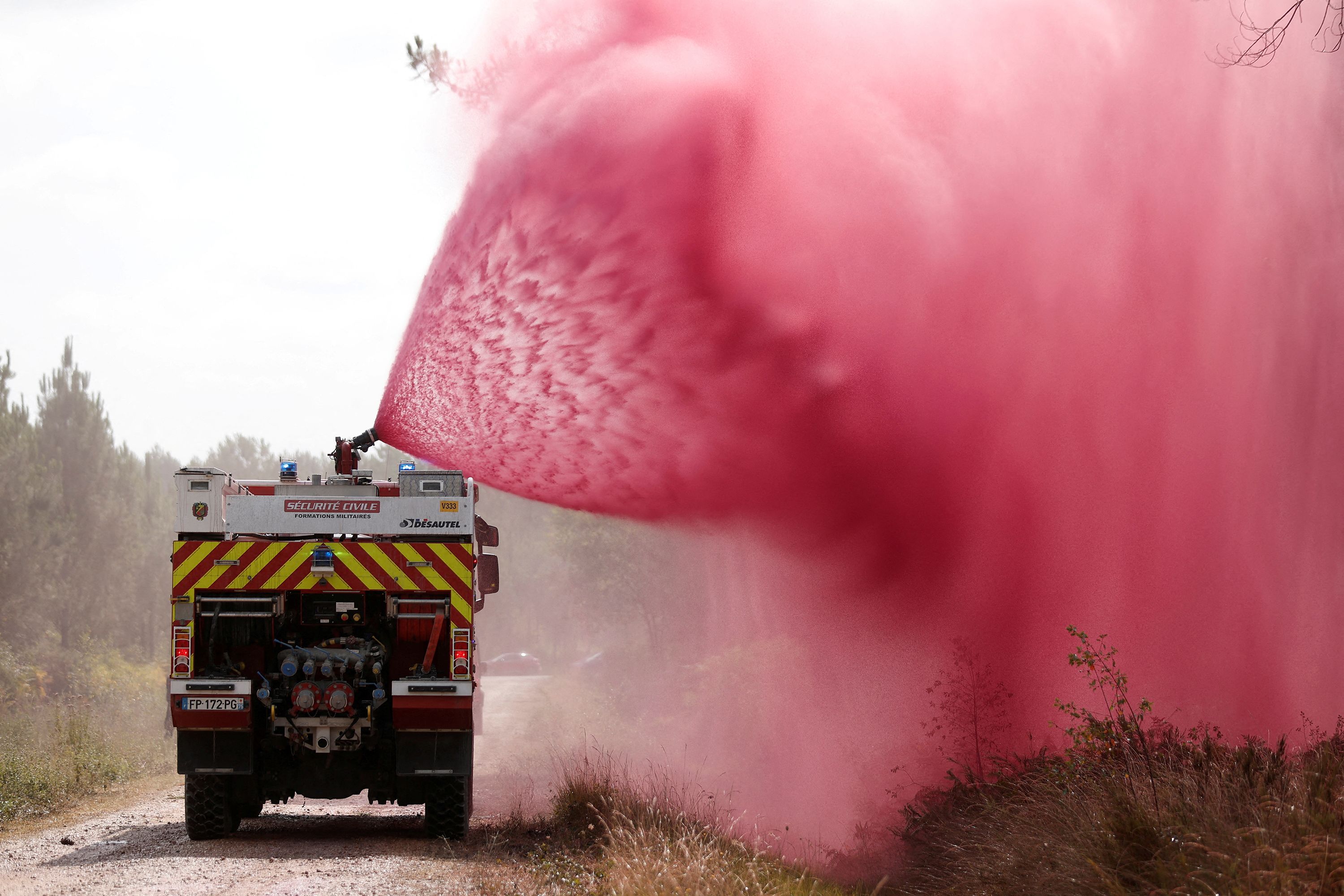 Firefighters spray flame retardant in Hostens, France, on July 22.