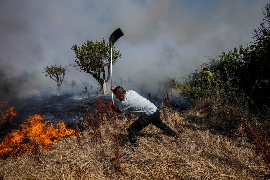 A local resident fights a fire with a shovel in Tabara, Spain, on July 19.