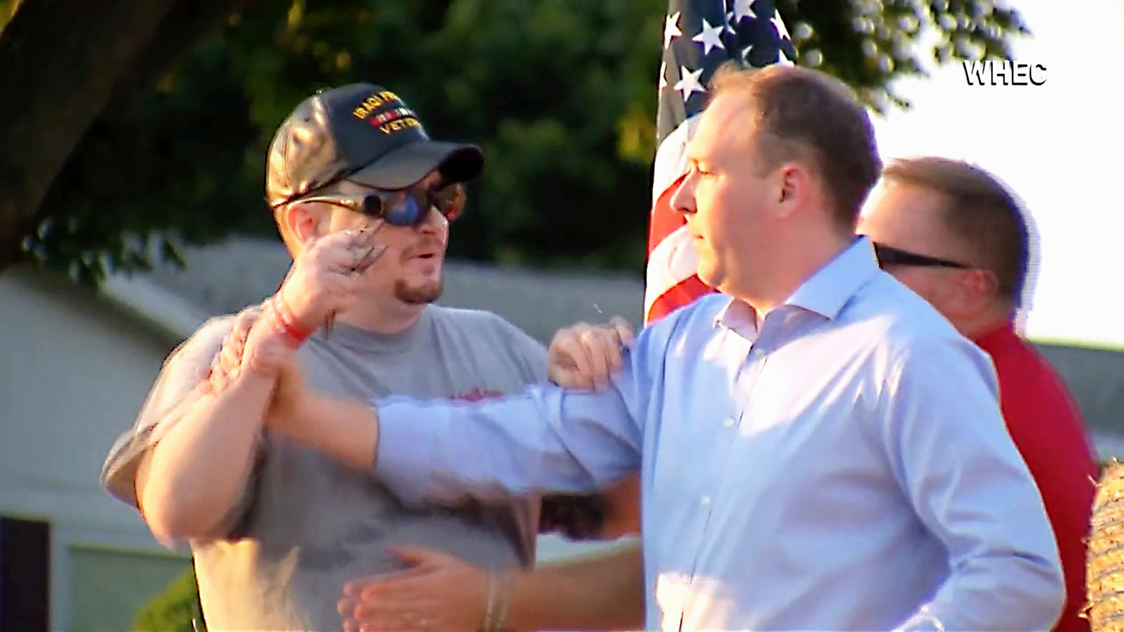 In this image taken from video provided by WHEC-TV, David Jakubonis, left, brandishes a sharp object as he attacks Rep. Lee Zeldin, right, as the Republican candidate for New York governor delivered a speech in Perinton, New York, Thursday, July 21, 2022.