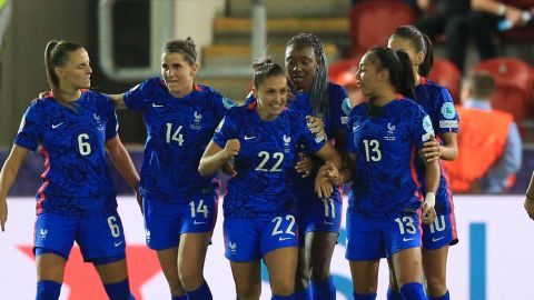 Perisset (3L) celebrates her goal with her teammates.