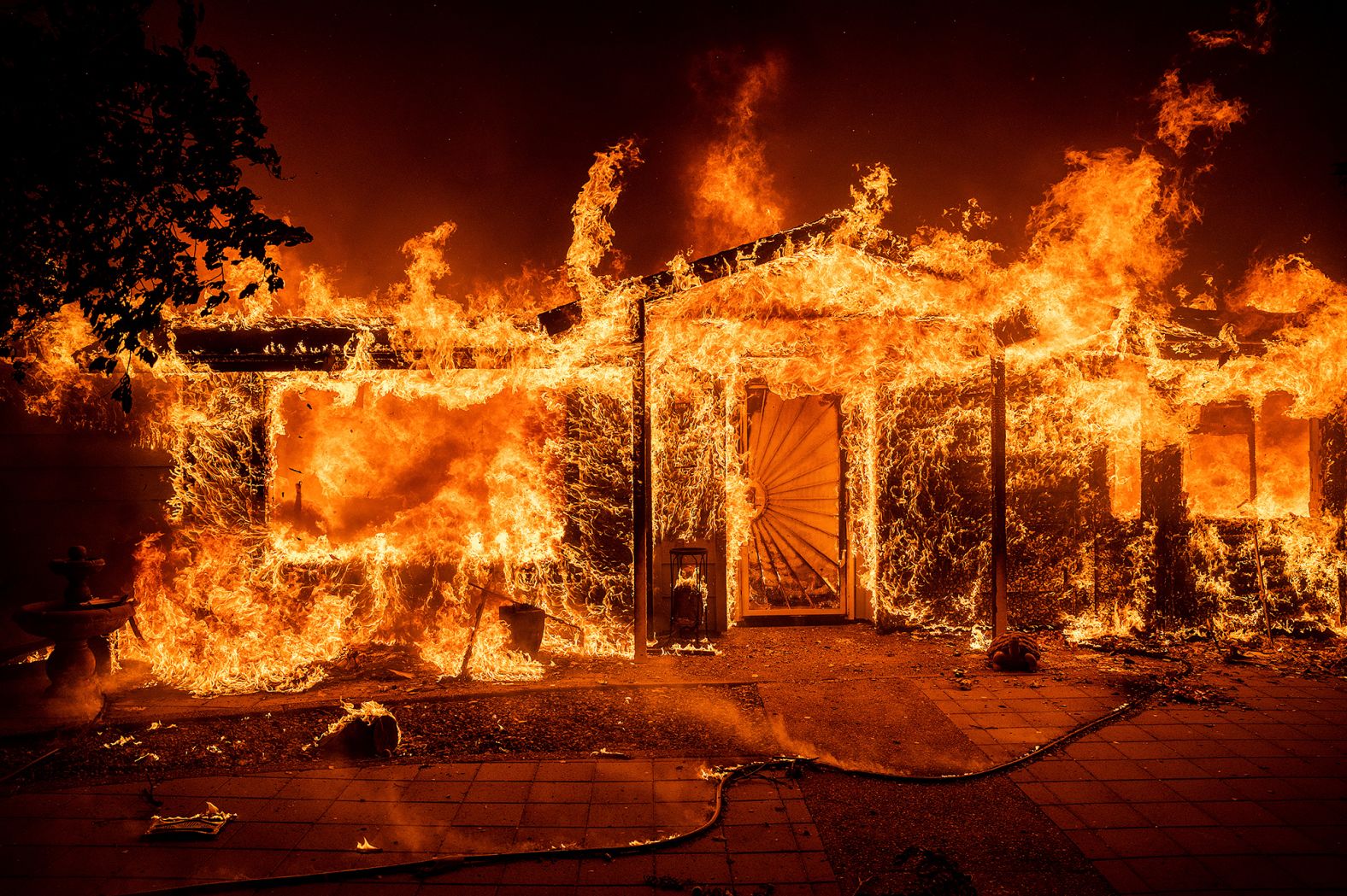 Flames consume a home in Mariposa County on Saturday.