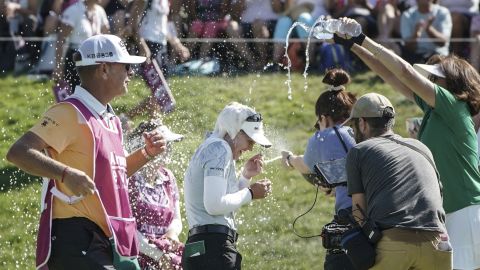 Brooke Henderson center, celebrated after winning the Evian Championship.