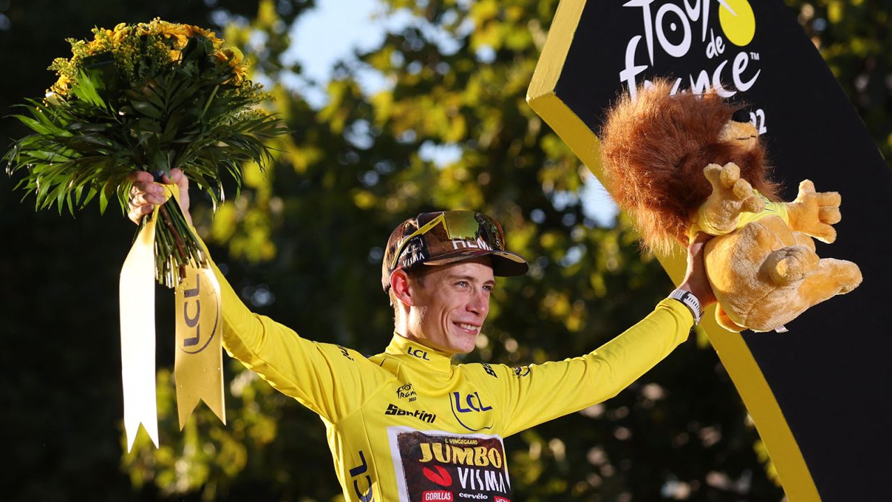Jumbo-Visma team's Danish rider Jonas Vingegaard celebrates on the podium with the overall leader's yellow jersey after winning the 109th edition of the Tour de France cycling race, after the 21st and final 115,6 km stage between La Defense Arena in Nanterre, outside Paris, and the Champs-Elysees in Paris, France, on July 24, 2022. (Photo by Thomas SAMSON / AFP) (Photo by THOMAS SAMSON/AFP via Getty Images)