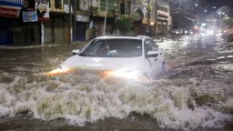 A vehicle drives along a flooded street, following heavy rains during the monsoon season in Karachi, Pakistan July 24, 2022. 