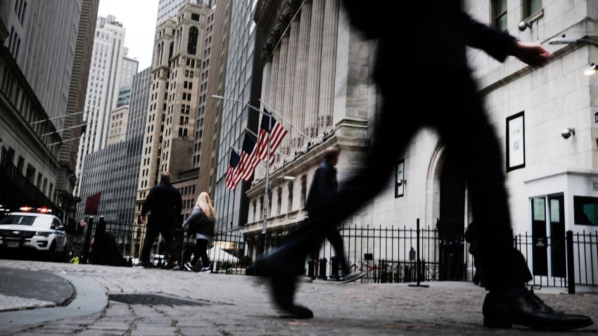 People walk by the New York Stock Exchange (NYSE) on April 25, 2022 in New York City.