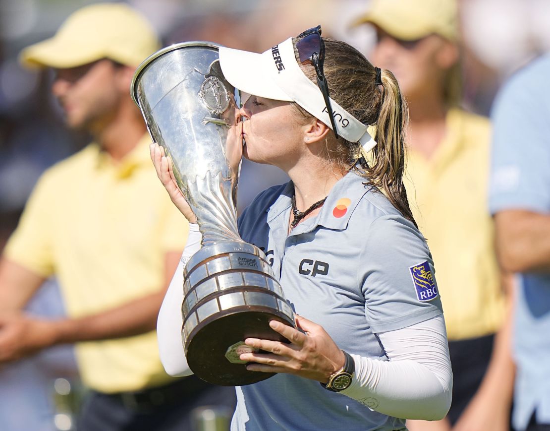 Henderson kisses the victor's trophy.