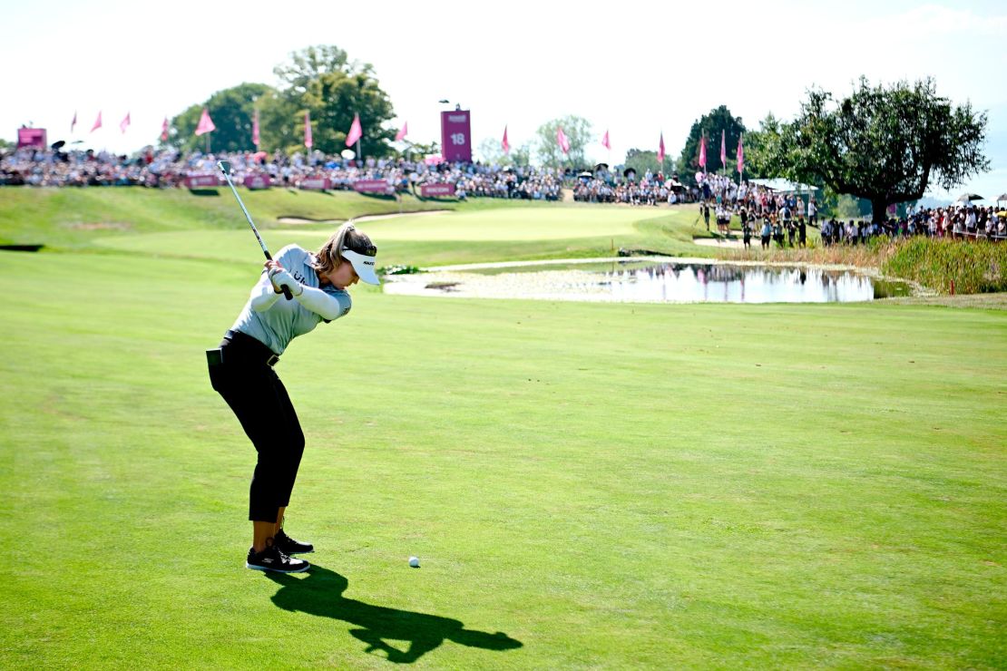 Henderson plays her second shot at the 18th hole.