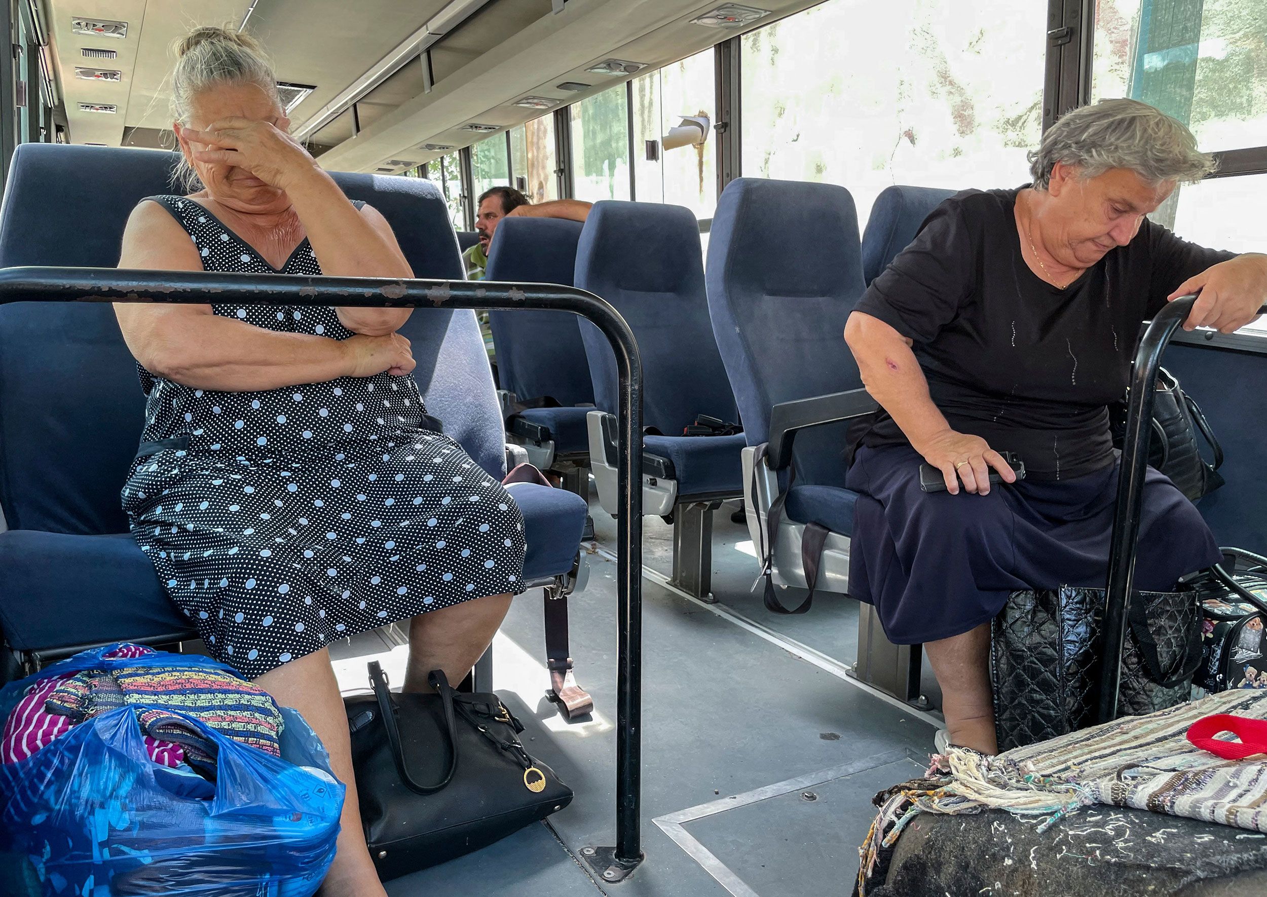 Residents of the Greek village of Vrisa wait to evacuate the area on July 24.