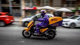 A courier for the food delivery service Getir, operated by Getir Perakende Lojistik AS, rides along a street in Barcelona, Spain, on Saturday, Feb. 12, 2022. 