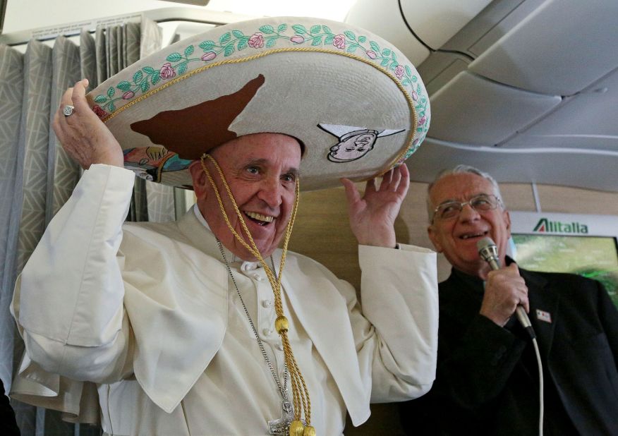 Francis tries on a traditional sombrero he received as a gift from a Mexican journalist while on a flight to the country in February 2016.